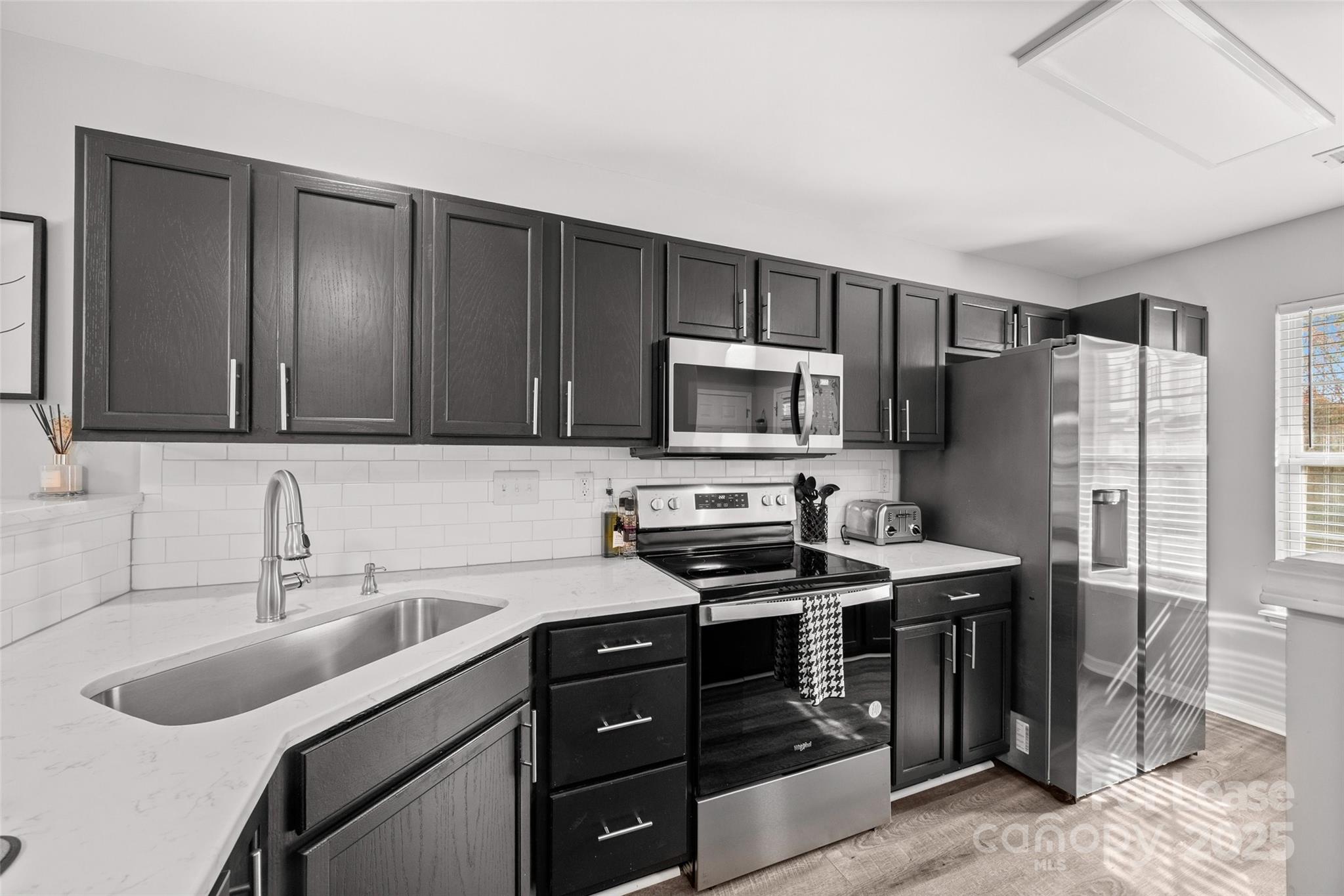 16865 Timber Crossing Road Charlotte, NC 28213 - Photo 4 of 39 a kitchen with a sink appliances and cabinets