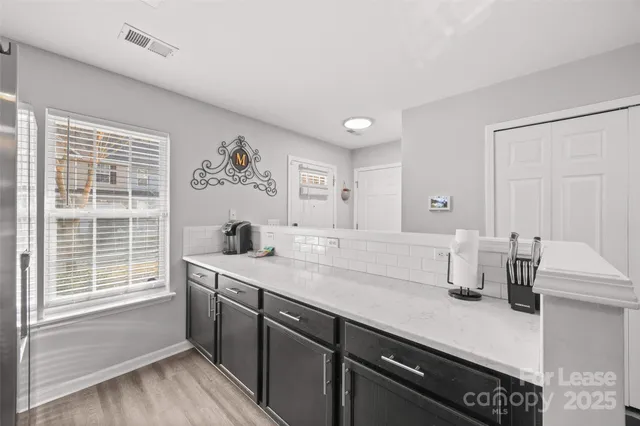 a kitchen with stainless steel appliances a sink stove and microwave
