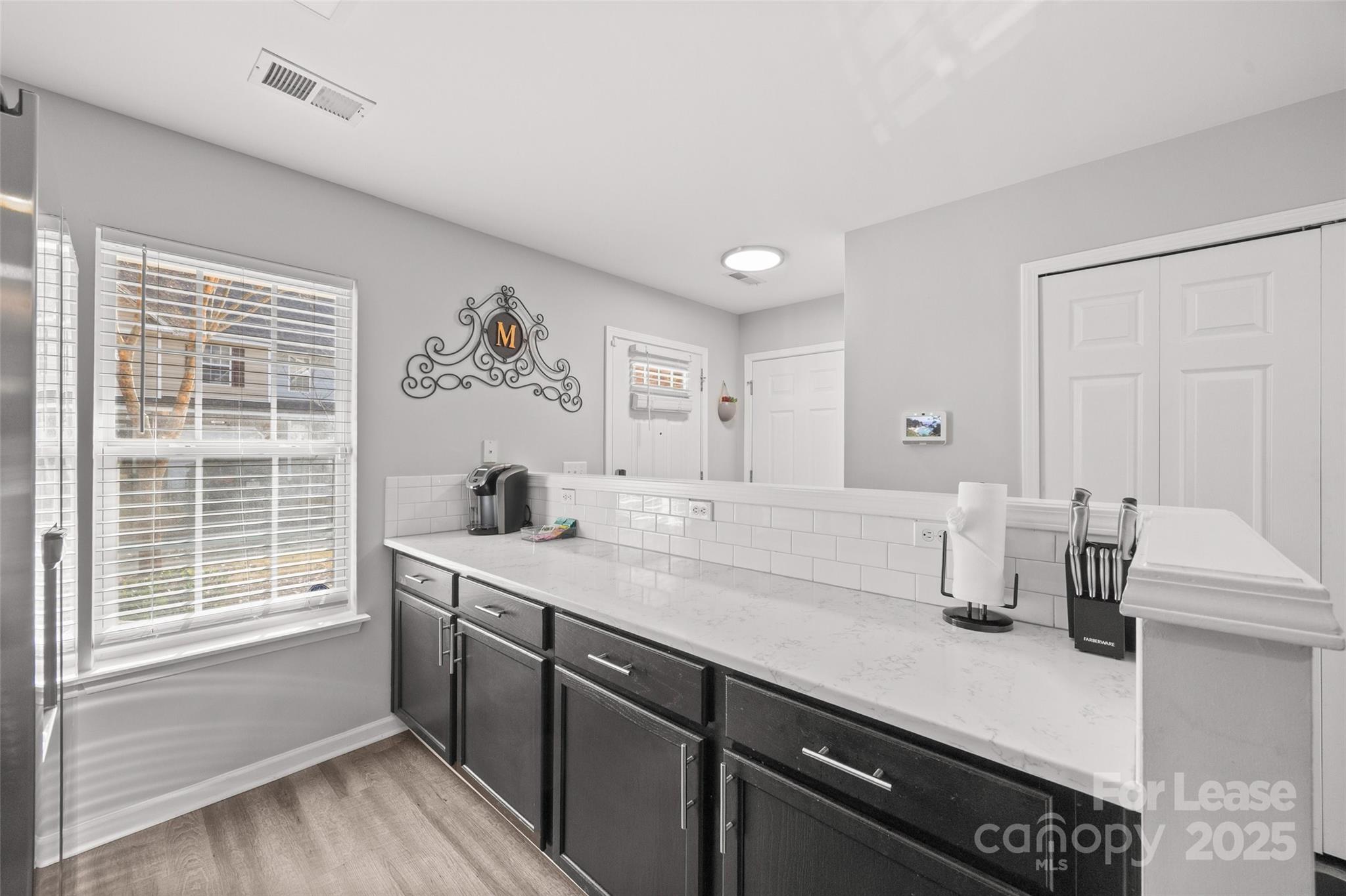 16865 Timber Crossing Road Charlotte, NC 28213 - Photo 5 of 39 a kitchen with a sink cabinets and wooden floor