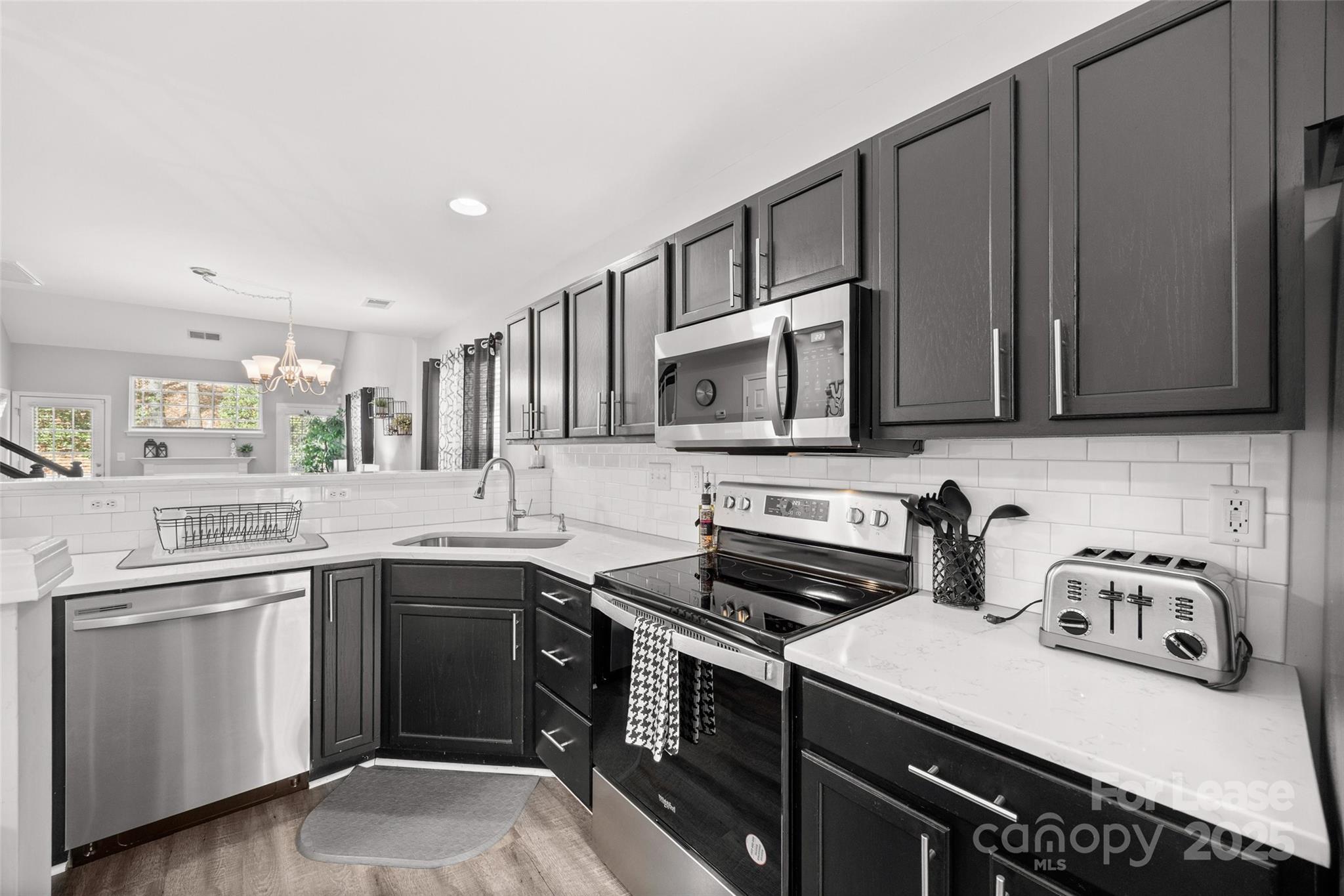 16865 Timber Crossing Road Charlotte, NC 28213 - Photo 6 of 39 a kitchen with stainless steel appliances a sink stove and microwave