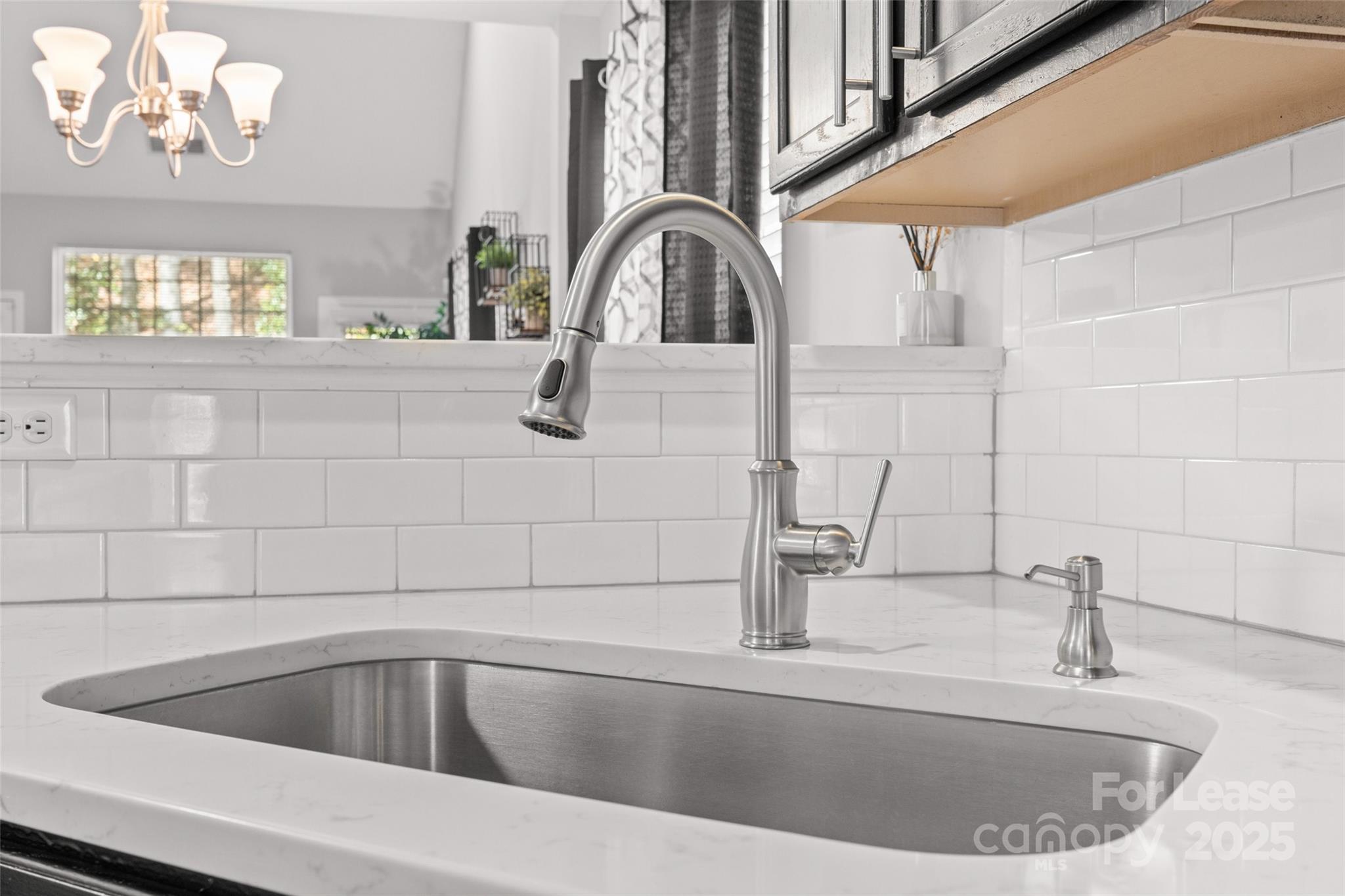 16865 Timber Crossing Road Charlotte, NC 28213 - Photo 7 of 39 a view of a sink a faucet a faucet and window in the kitchen