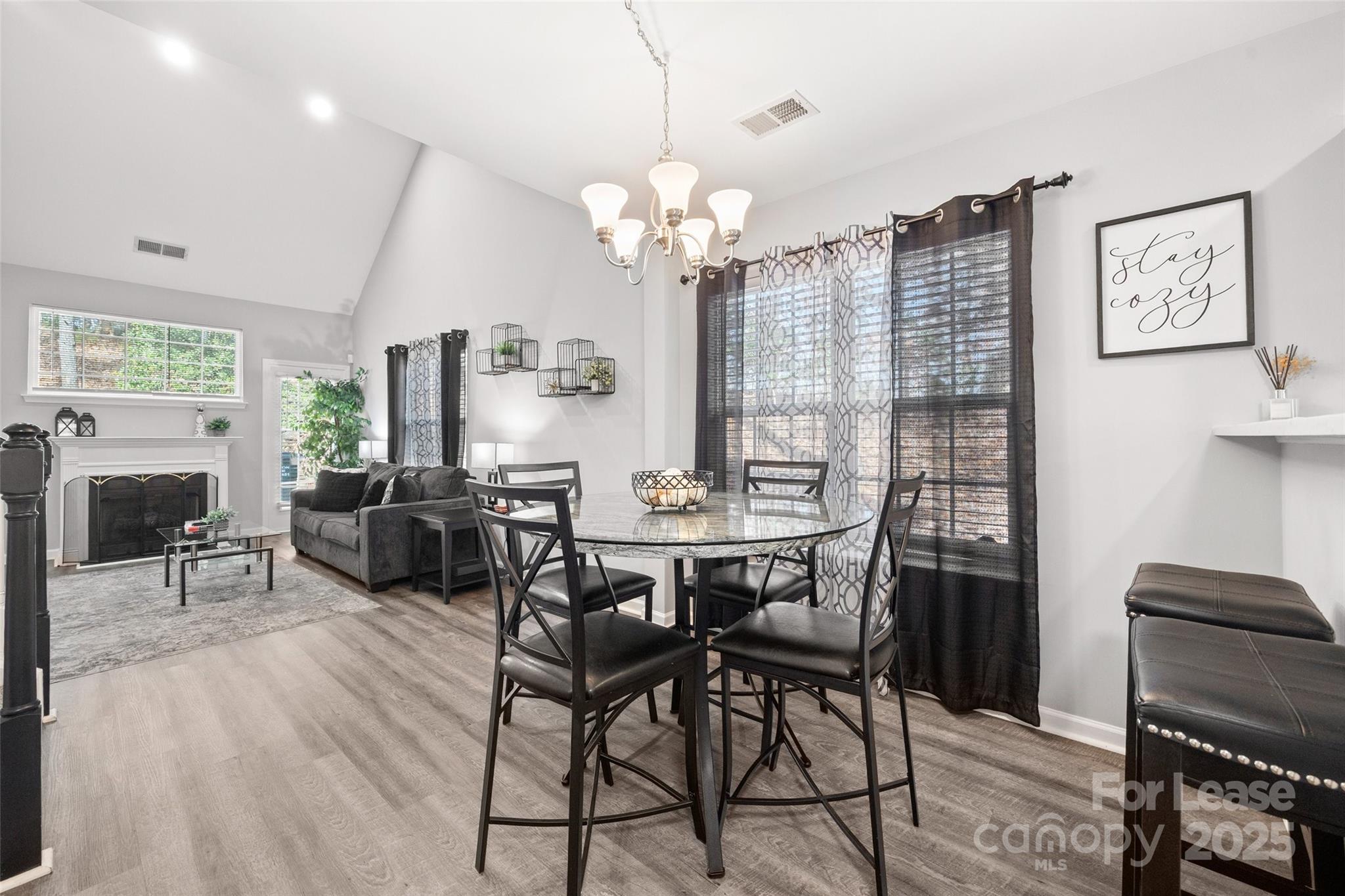 16865 Timber Crossing Road Charlotte, NC 28213 - Photo 8 of 39 a view of a dining room with furniture a chandelier and wooden floor