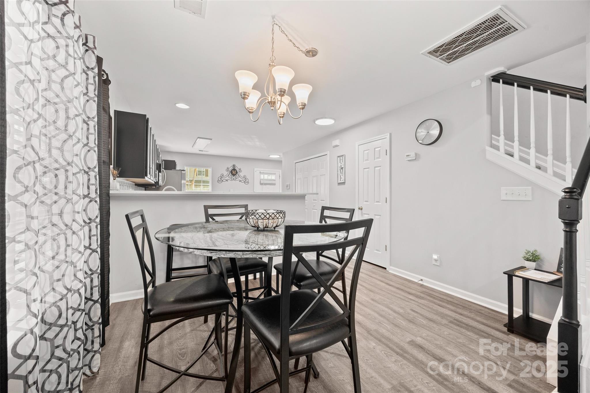 16865 Timber Crossing Road Charlotte, NC 28213 - Photo 9 of 39 a view of a dining room with furniture and wooden floor
