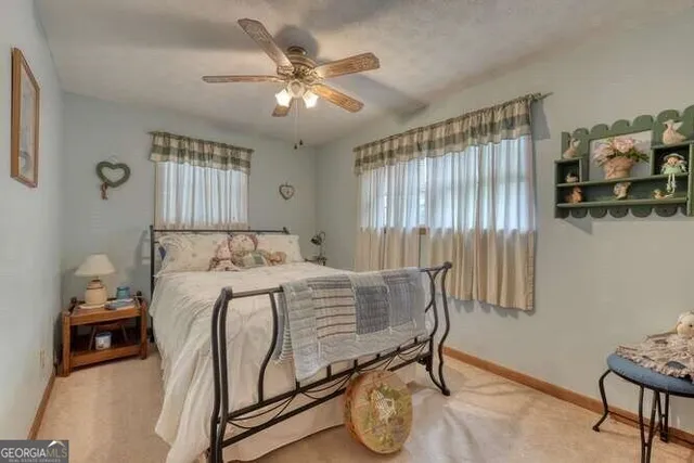 a bedroom with a bed and ceiling fan