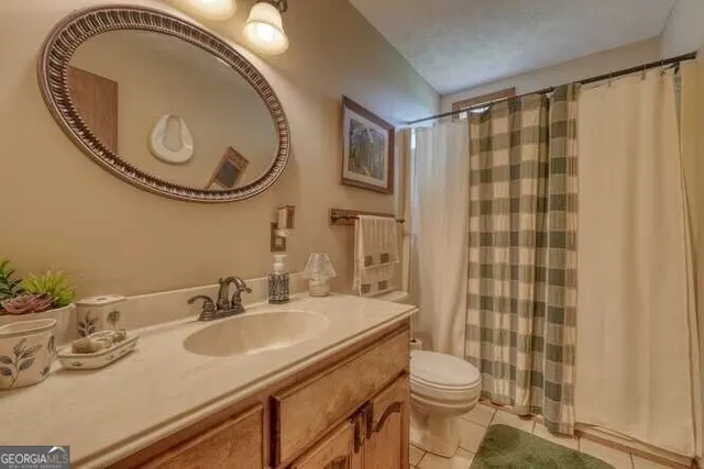 a bedroom with a bed and a large mirror with a large window