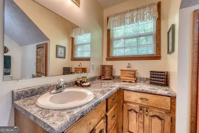 a bathroom with a toilet sink and mirror