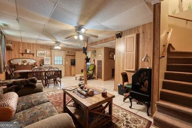 a bedroom with a bed a chandelier and a window