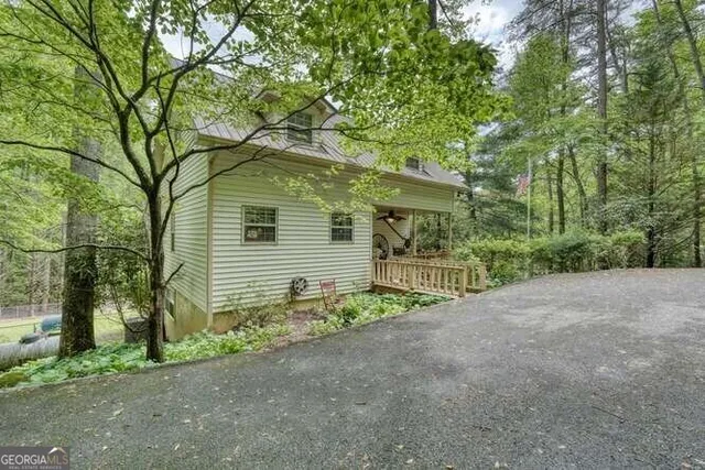 a view of a backyard with table and chairs and wooden fence