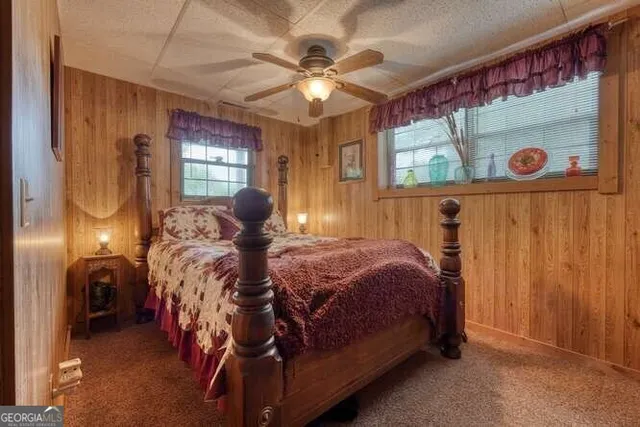 a patio with table and chairs and potted plants