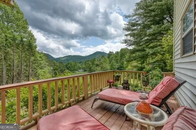 a living room with furniture a couch and a painting on the wall