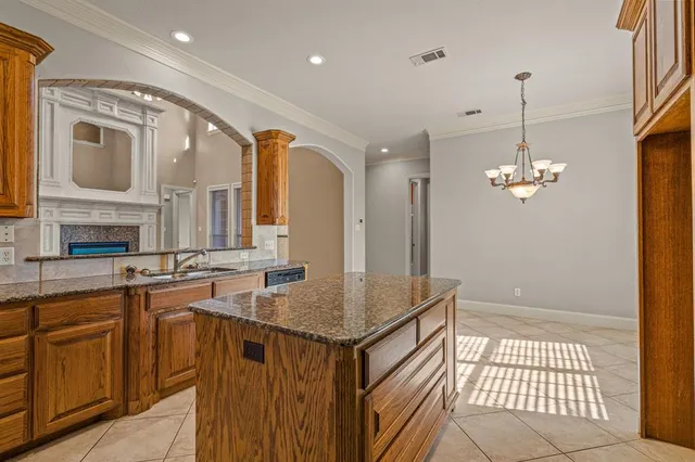 a kitchen with a sink refrigerator and cabinets