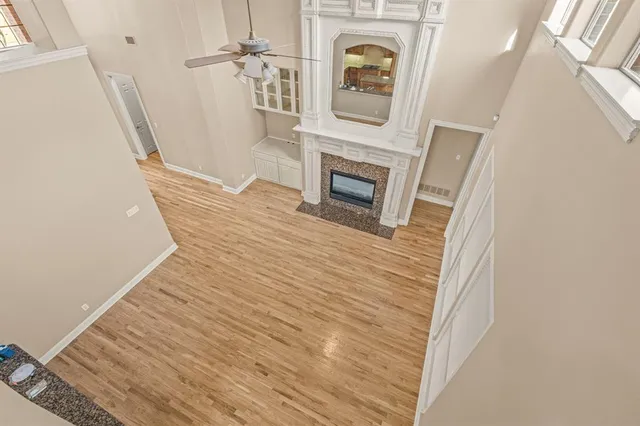 a view of a hallway with wooden floor and staircase
