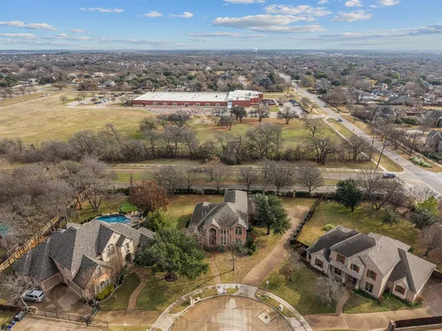 an aerial view of a residential houses with outdoor space