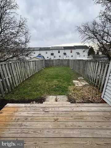 a view of a garden and wooden fence