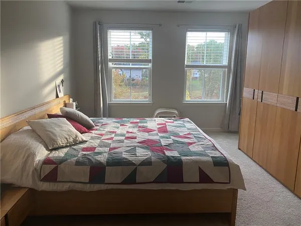 a bedroom with a bed and window