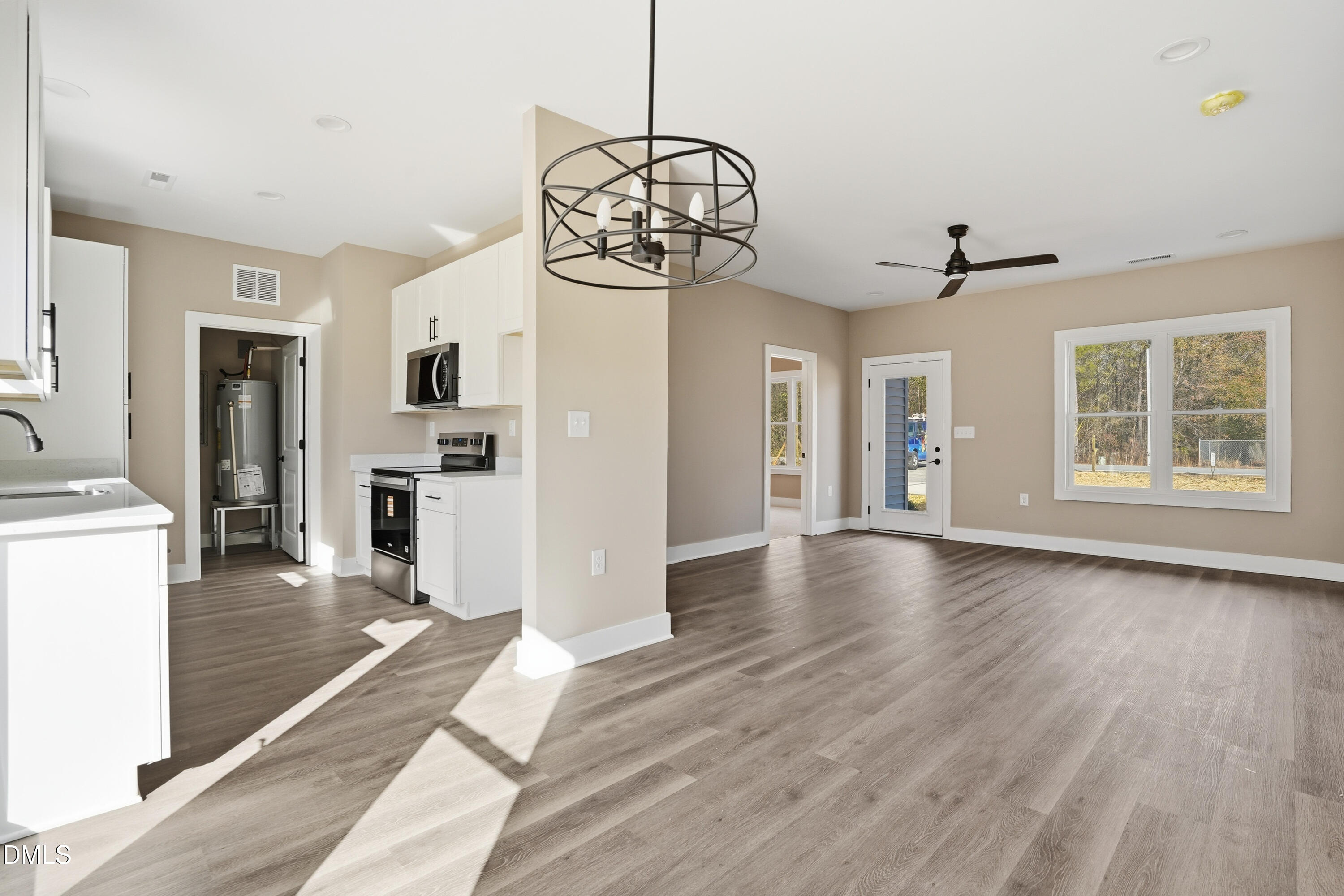 1115 Jada Allen Road Dunn, NC 28334 - Photo 9 of 32 a view of a room with wooden floor fireplace and windows