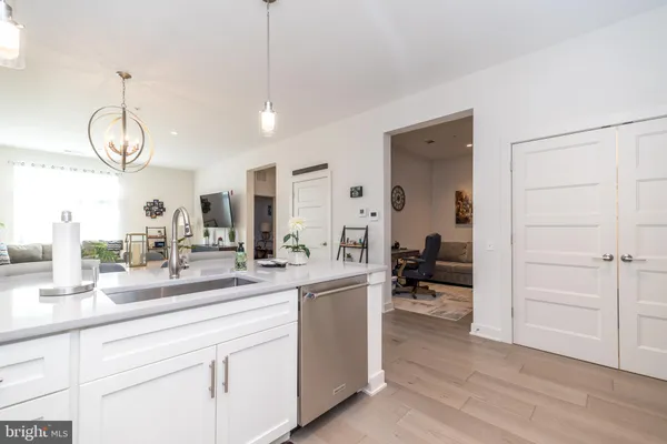 a kitchen with refrigerator and chairs