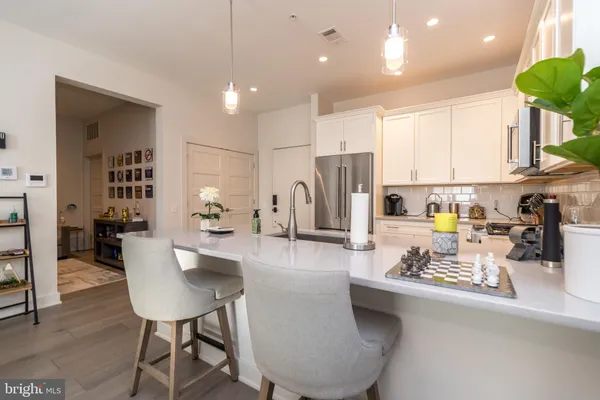 a kitchen with cabinets appliances a sink and a microwave