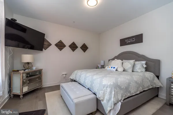 a bedroom with a bed and a tv