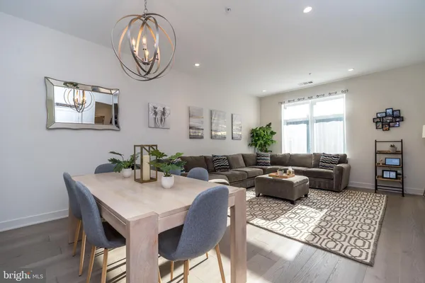 a living room with furniture a chandelier and a window