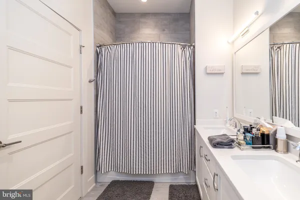 a bathroom with a double vanity sink and mirror