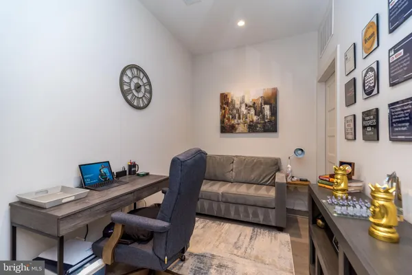 a living room with furniture and wall paintings