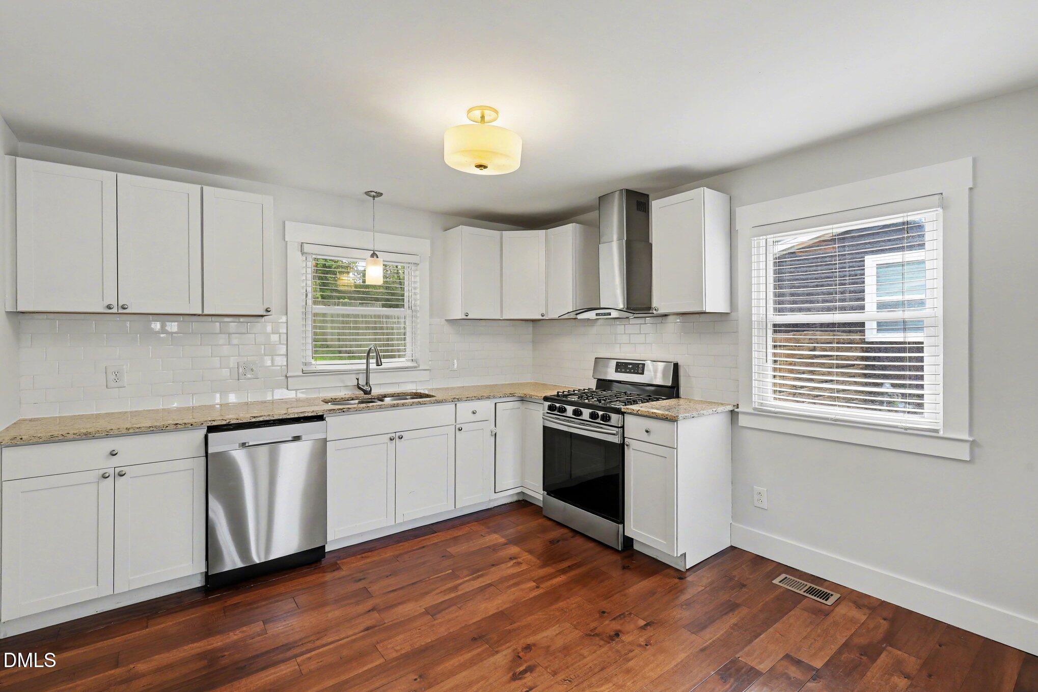 727 South State Street Raleigh, NC 27601 - Photo 11 of 30 a kitchen with stainless steel appliances granite countertop a sink and a stove top oven