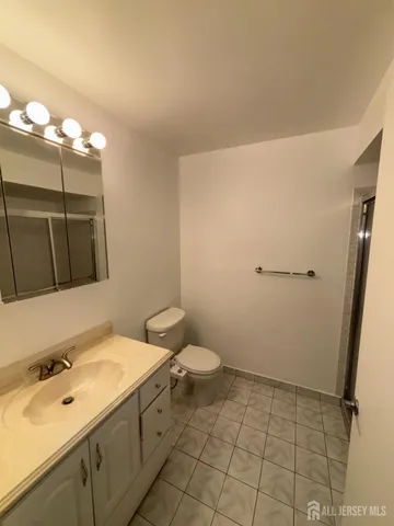 a view of a hallway with wooden floor and closet