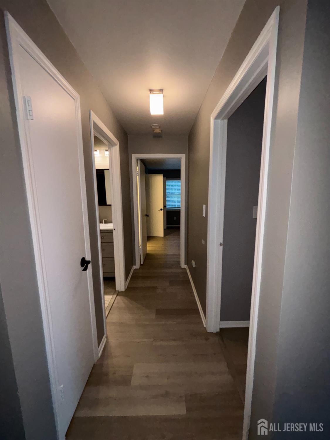 42 B Powderhorn Court, Unit 42B Woodbridge, NJ 07095 - Photo 13 of 14 a view of a hallway with wooden floor and closet