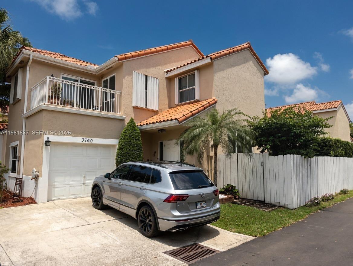 a car parked in front of a white house