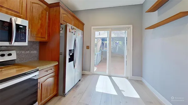 a kitchen with a refrigerator and a sink