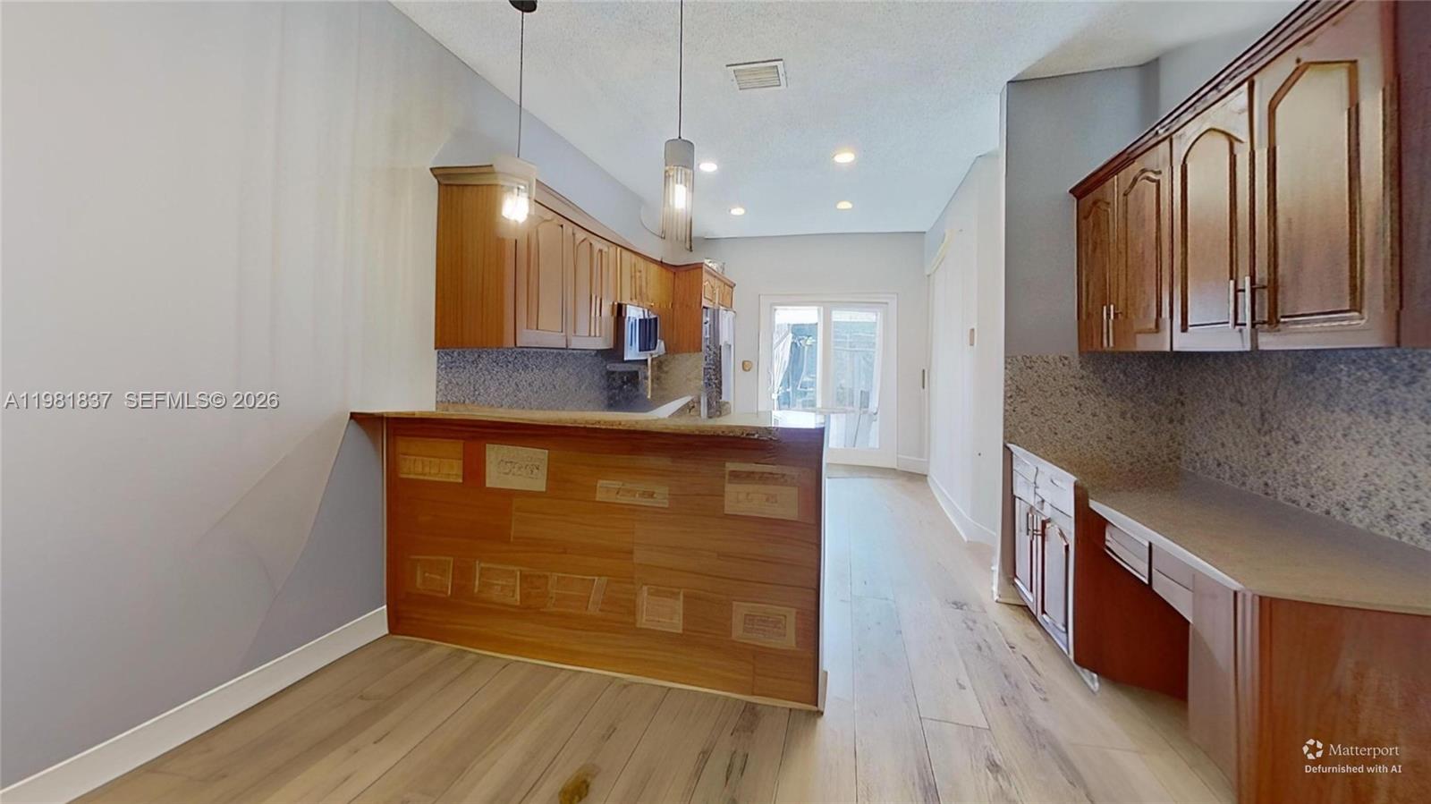 3760 Westminster Street Hollywood, FL 33021 - Photo 13 of 42 a kitchen with stainless steel appliances granite countertop a stove a sink and a refrigerator