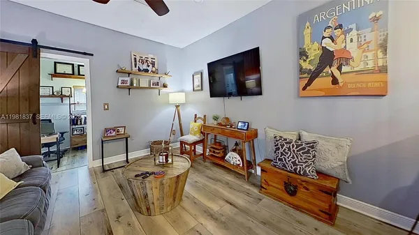 a living room with furniture and wooden floor