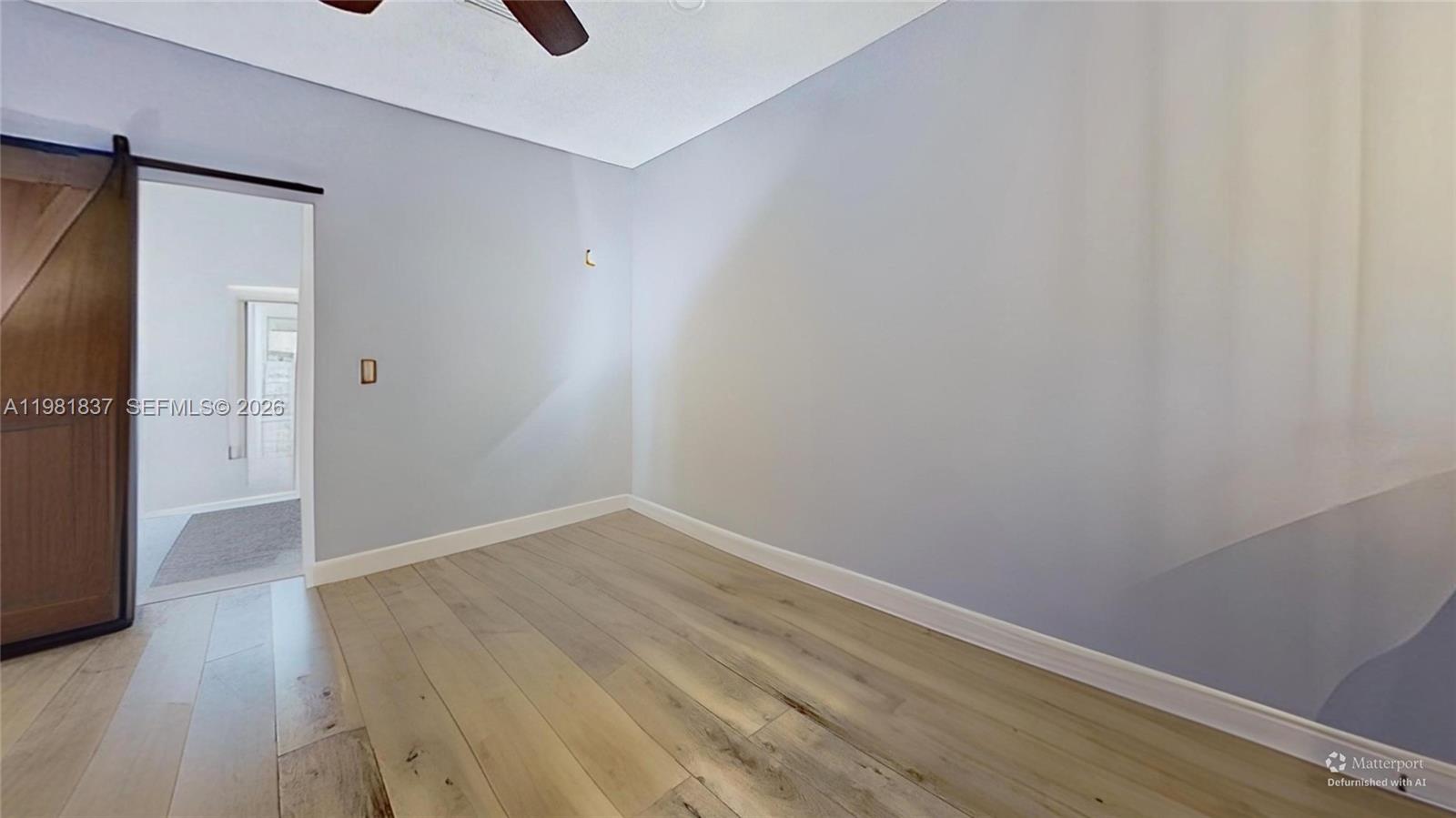 3760 Westminster Street Hollywood, FL 33021 - Photo 15 of 42 a view of an empty room with wooden floor and a window