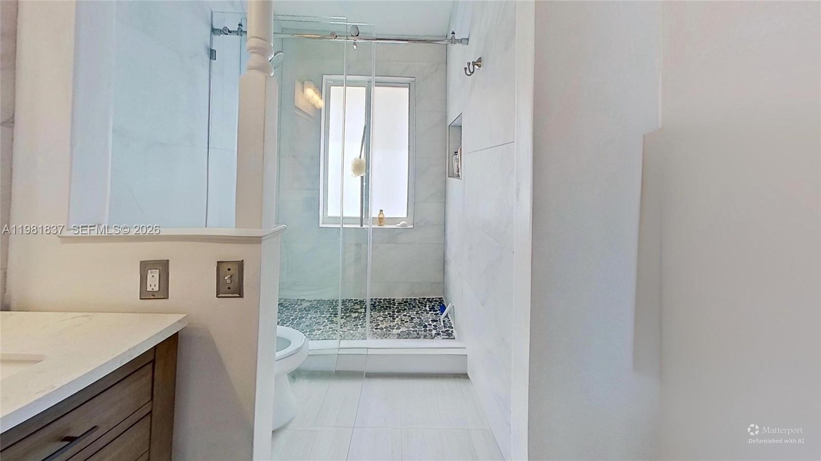 3760 Westminster Street Hollywood, FL 33021 - Photo 18 of 42 a bathroom with a granite countertop sink a toilet and shower