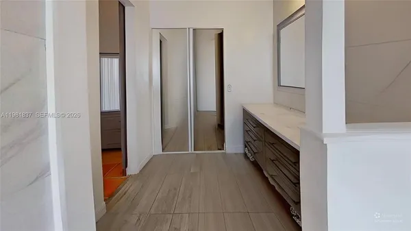 a view of hallway with wooden floor