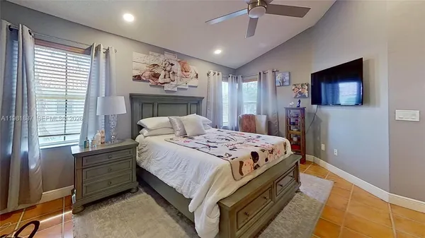 a bedroom with a bed and a flat screen tv