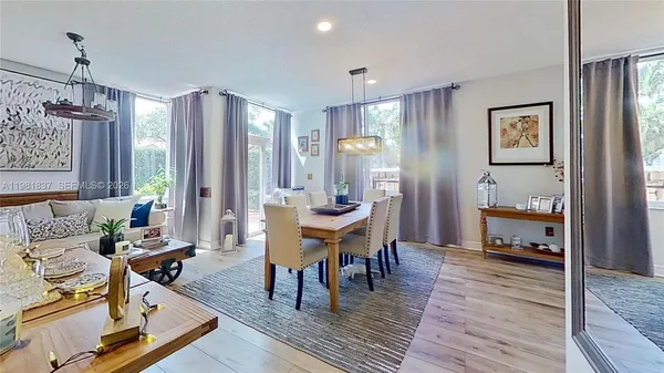 a living room with furniture a table and wooden floor