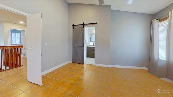 an empty room with windows and closet