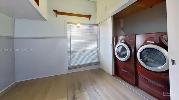 a view of walk in closet with wooden floor