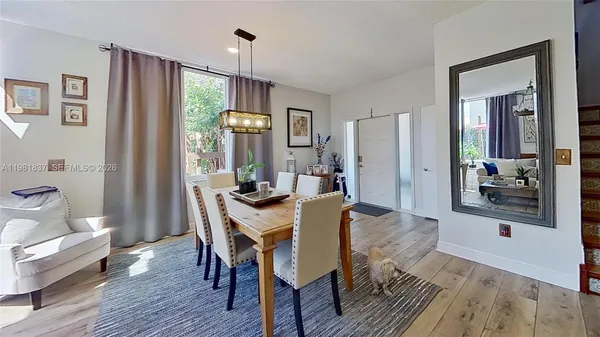 a view of a dining room with furniture window and wooden floor
