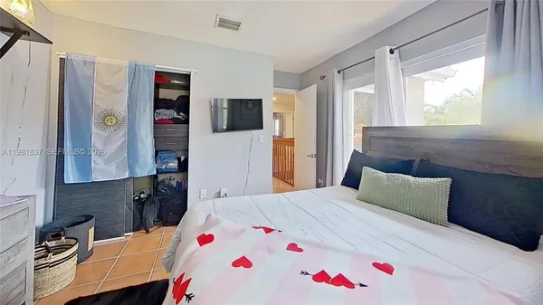 a bedroom with a bed and a window