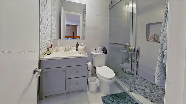 a bathroom with a sink toilet and mirror