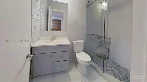 a bathroom with a sink toilet and mirror