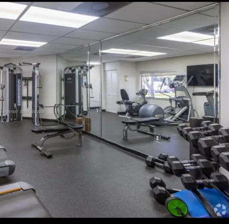 a room with gym equipment and a large window