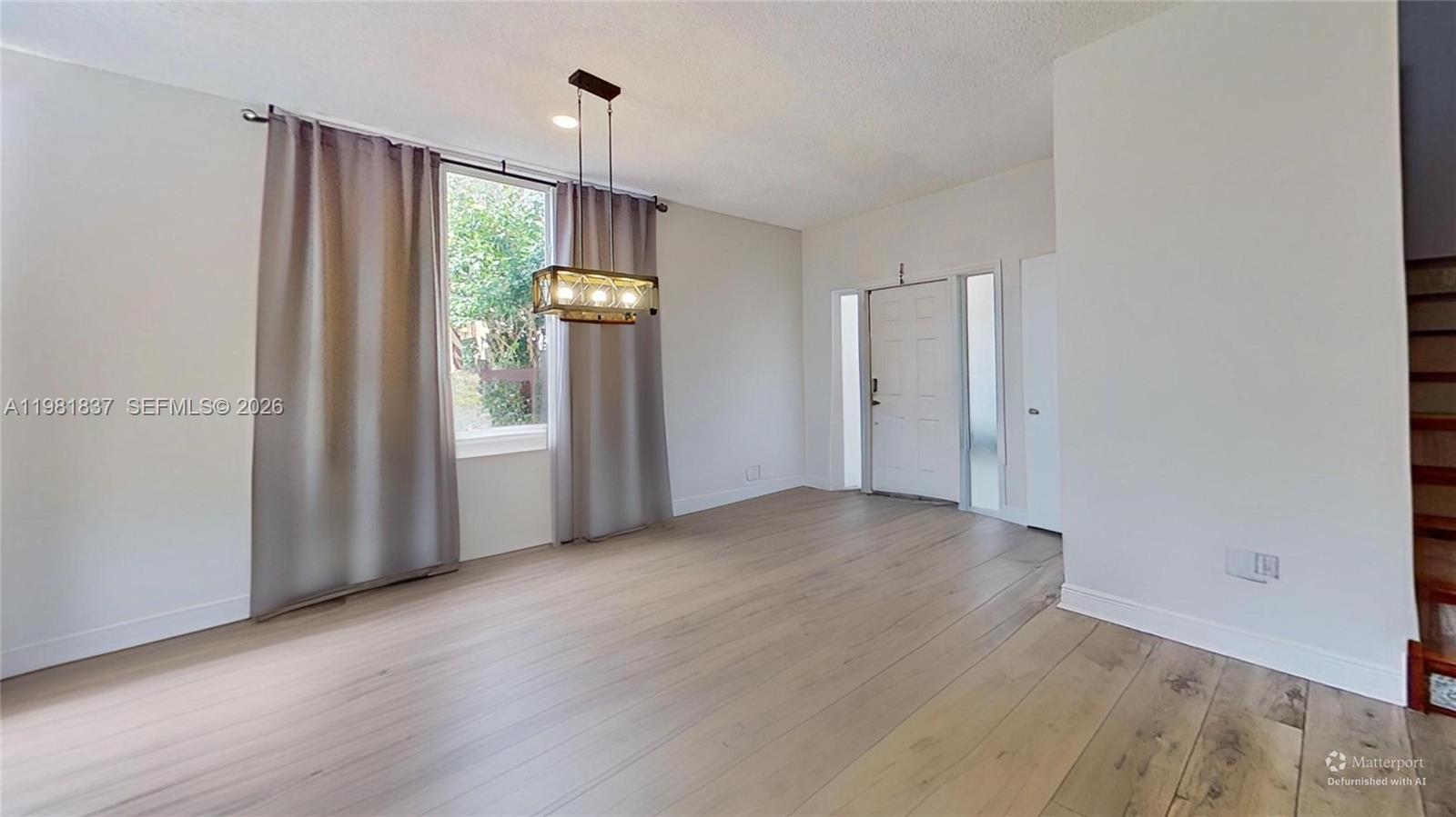 3760 Westminster Street Hollywood, FL 33021 - Photo 8 of 42 an empty room with wooden floor and windows