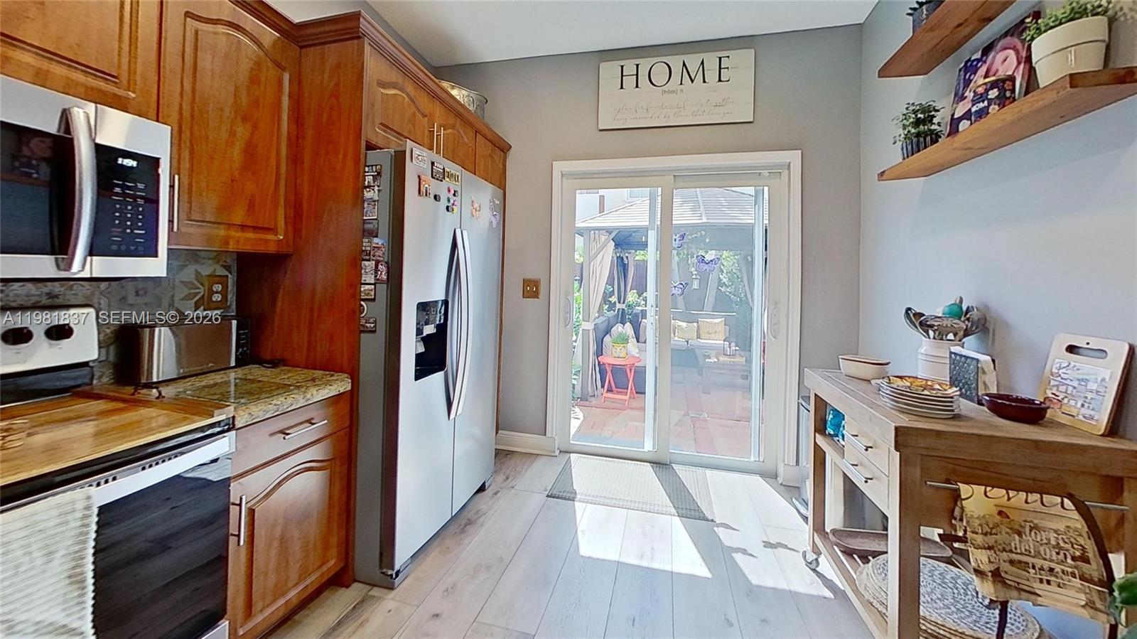 3760 Westminster Street Hollywood, FL 33021 - Photo 10 of 42 a kitchen with stainless steel appliances granite countertop a refrigerator a stove top oven a sink and dishwasher