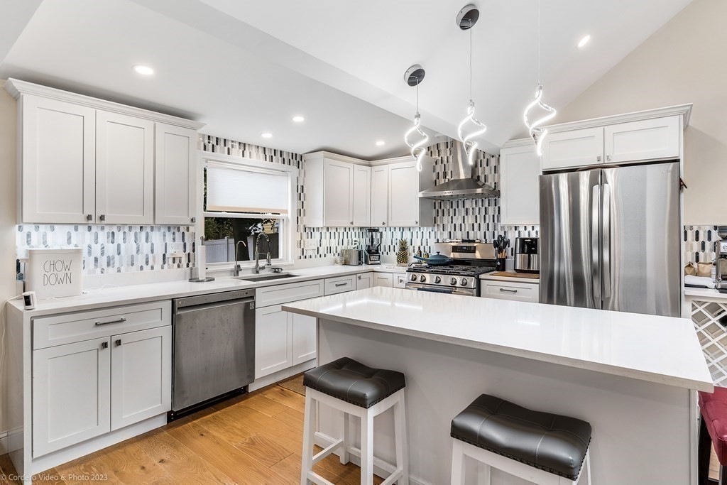 26 Mill Street Maynard, MA 01754 - Photo 11 of 29 a kitchen with stainless steel appliances a sink stove and refrigerator