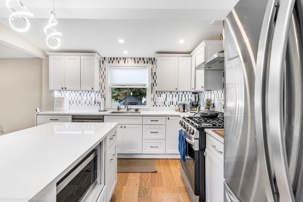 26 Mill Street Maynard, MA 01754 - Photo 12 of 29 a kitchen with a sink stove and cabinets