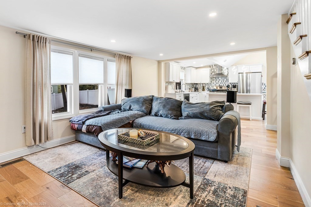 26 Mill Street Maynard, MA 01754 - Photo 17 of 29 a living room with furniture and a large window